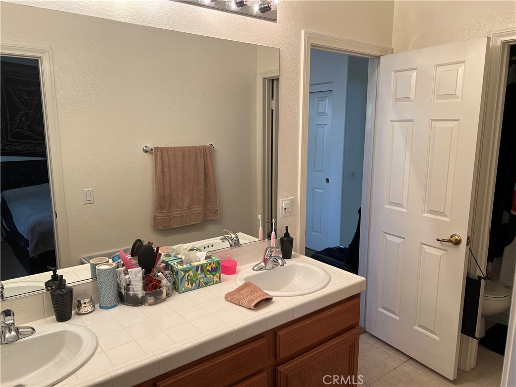 31458 Inverness Court Temecula, CA 92591 - Photo 33 of 33 a bathroom with a sink and a mirror