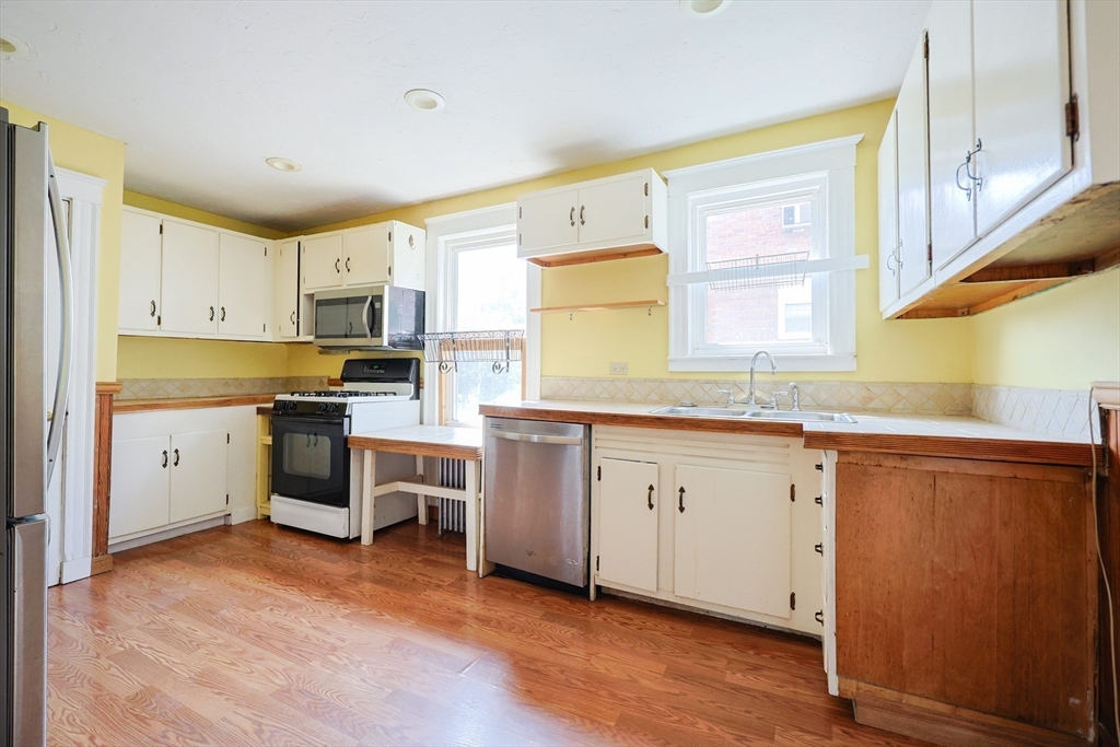 29 Margaret Road Newton, MA 02461 - Photo 11 of 33 a kitchen with white cabinets and white appliances