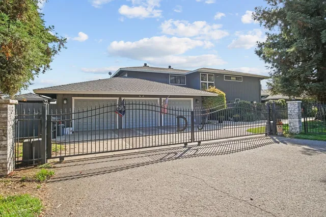 a view of a house with a wooden fence