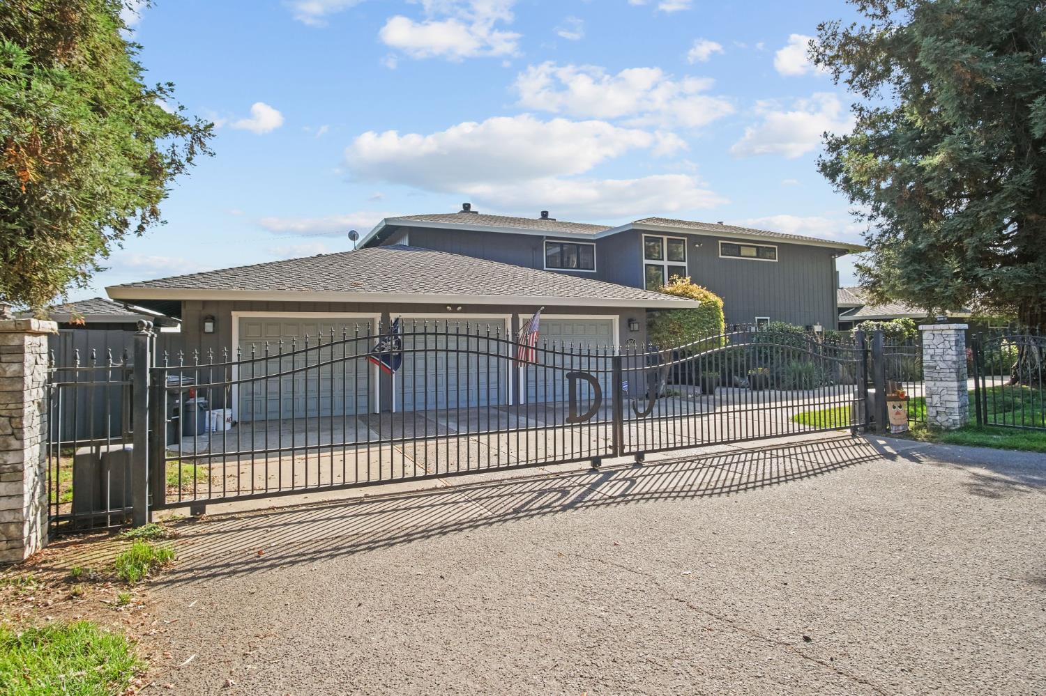 a view of a house with a wooden fence