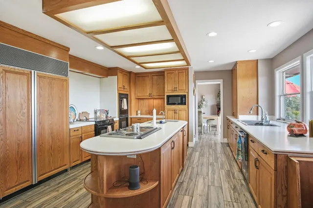 a kitchen with a sink stove and cabinets