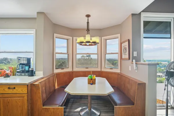 a room with pool table and windows
