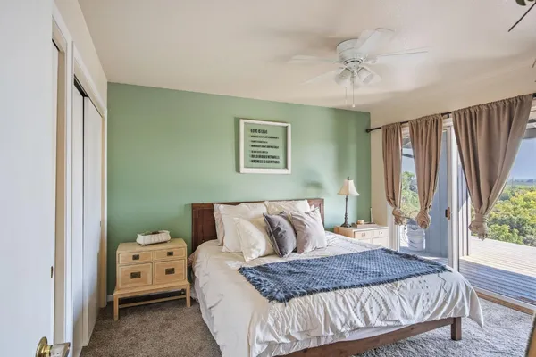 a spacious bedroom with a bed and a large window