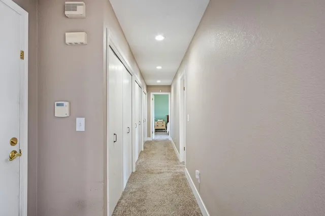 a spacious bedroom with a bed and a large window