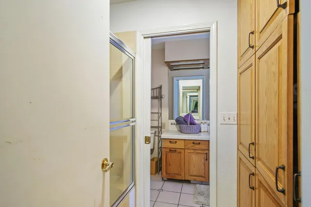 a bathroom with a granite countertop sink toilet and a mirror