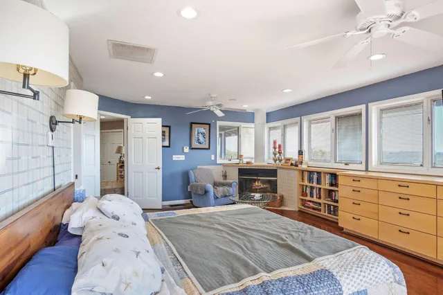 a view of a hallway with wooden floor and a window