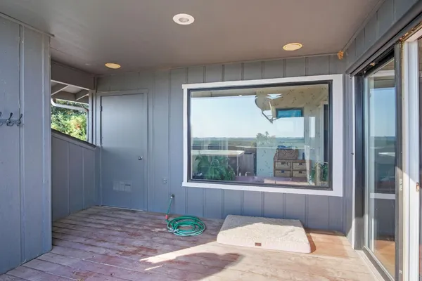 a view of a patio with a table and chairs under an umbrella
