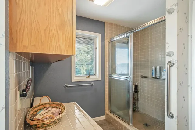 a view of a patio with a table and chairs under an umbrella