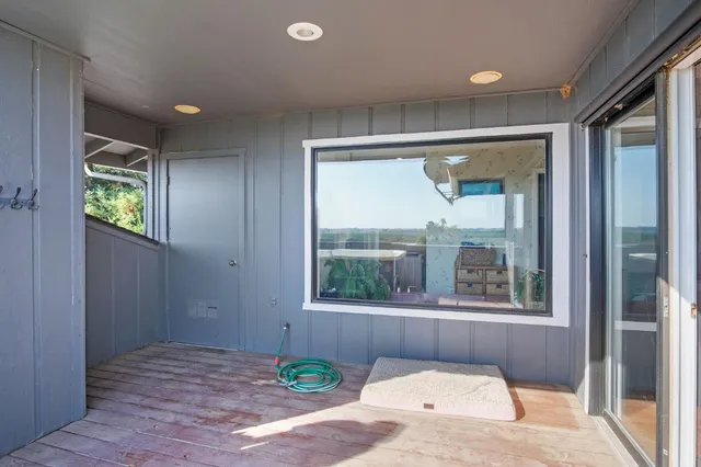a view of a backyard with a patio and wooden fence