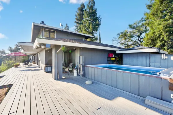 an aerial view of residential houses with outdoor space and swimming pool