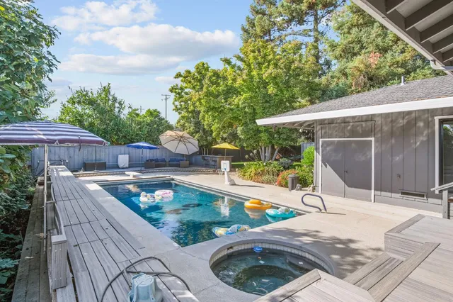 aerial view of a house with swimming pool and sitting area