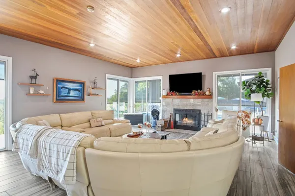 a living room with furniture a fireplace and a flat screen tv
