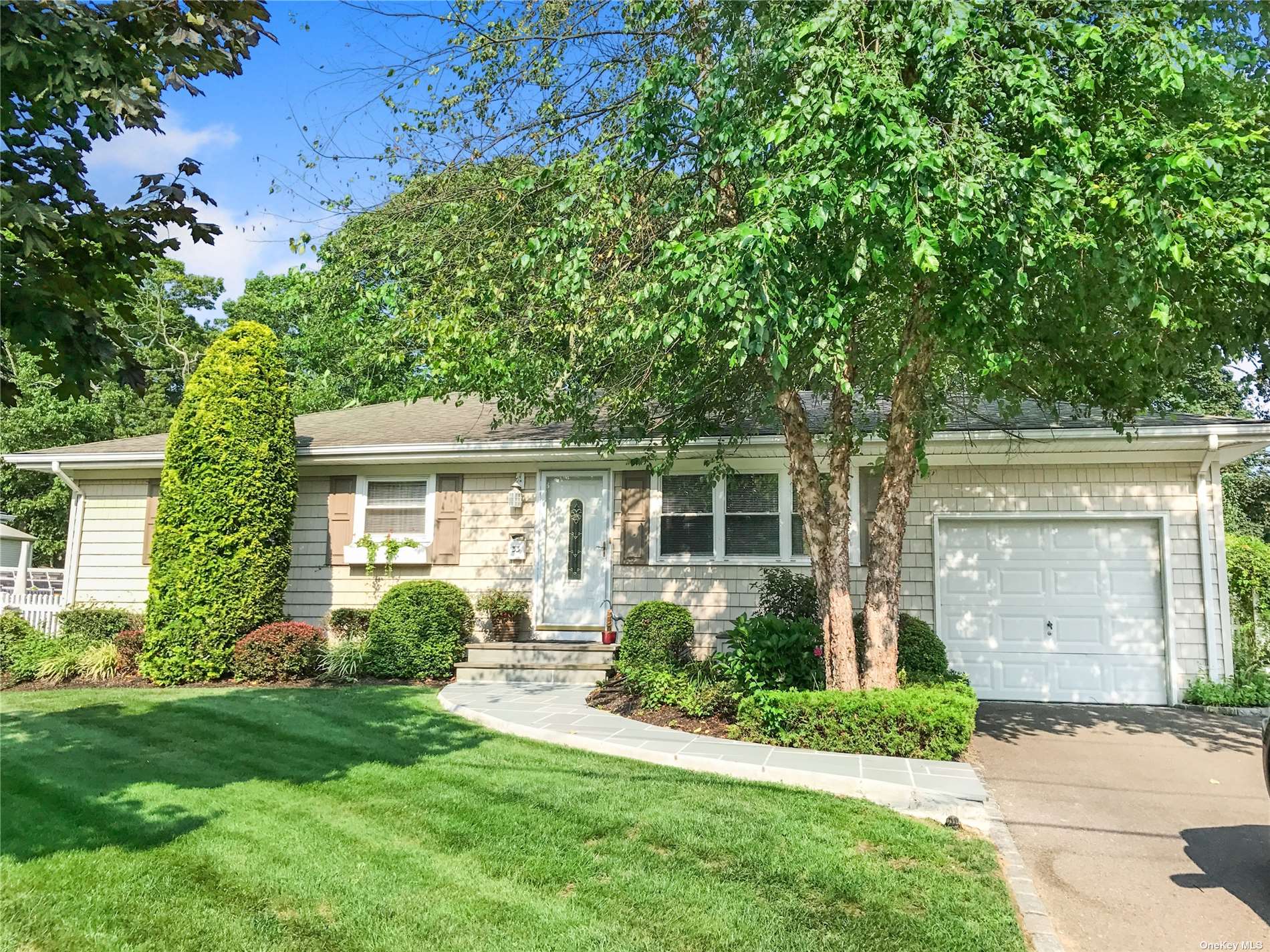 33 Bieselin Road Bellport, NY 11713 - Photo 1 of 1 front view of a house with a yard