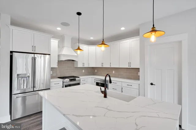 a kitchen with a sink and a fireplace with wooden floor