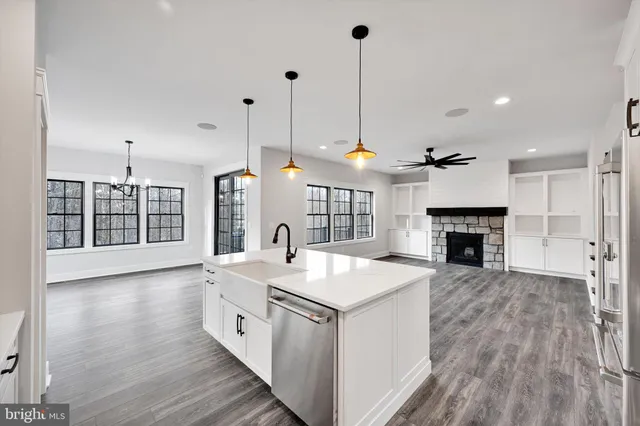 a kitchen with a sink window and stainless steel appliances