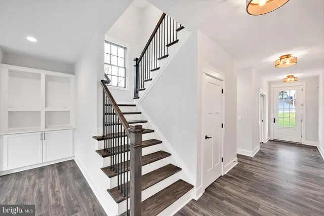 a view of empty room with wooden floor and window