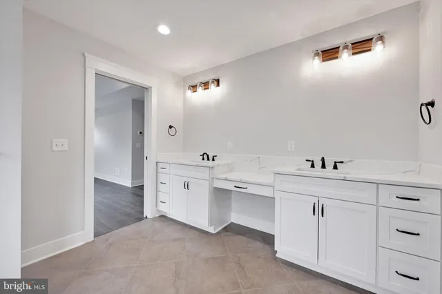 a bathroom with a bathtub sink mirror and toilet