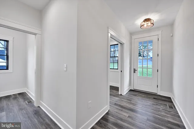 a bathroom with a granite countertop sink toilet and mirror