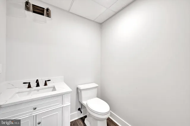 a balcony with wooden floor next to a yard