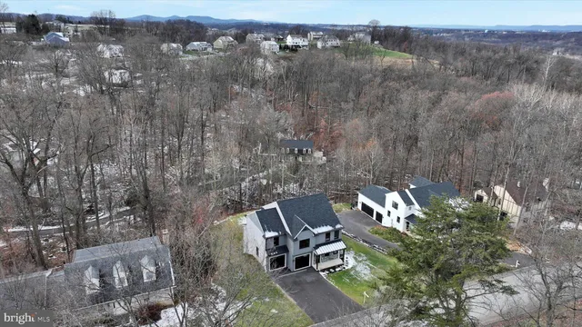 a aerial view of a house with a yard table and chairs