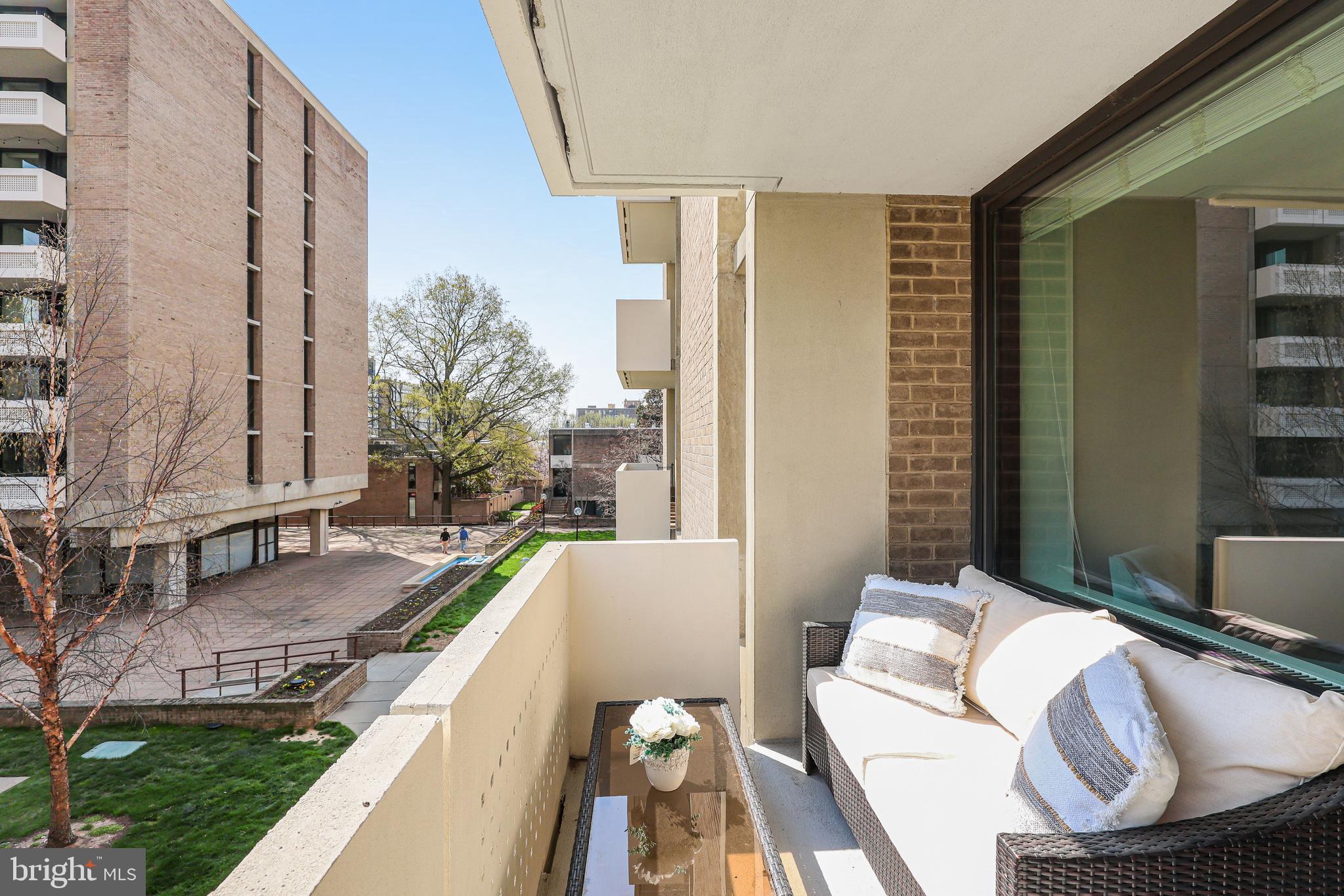 300 M Street Southwest, Unit N102 Washington, DC 20024 - Photo 13 of 53 a balcony with furniture and a potted plant
