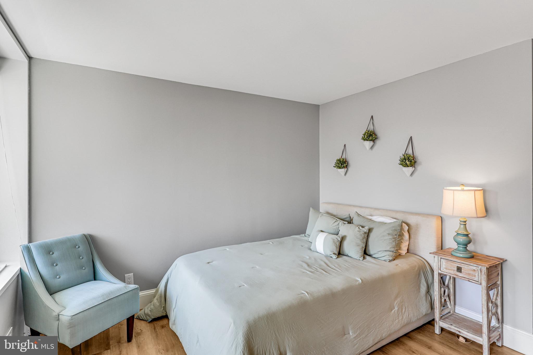 300 M Street Southwest, Unit N102 Washington, DC 20024 - Photo 14 of 53 a bedroom with a bed and chair