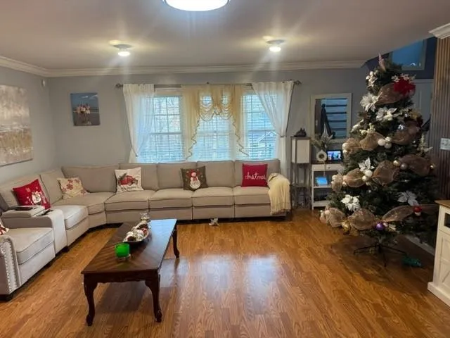 a living room with furniture window and wooden floor