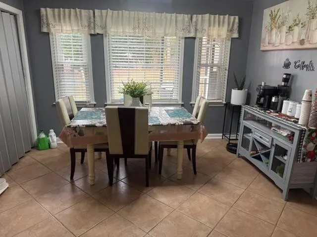 a dining room with furniture and windows