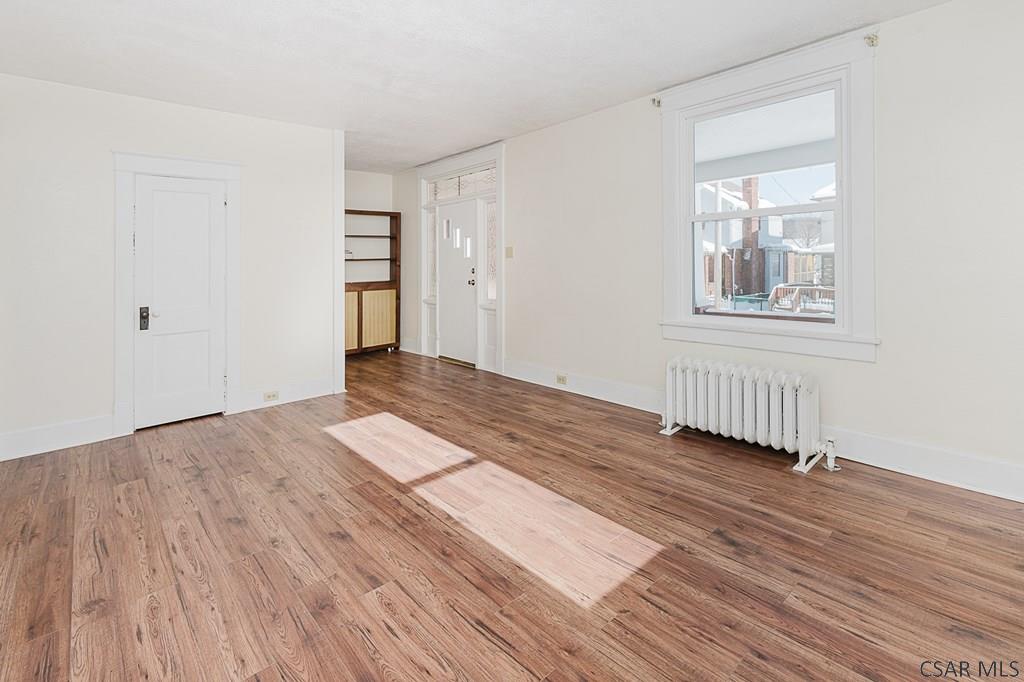 159 Wilson Street Johnstown, PA 15906 - Photo 5 of 27 a view of an empty room with wooden floor and a window