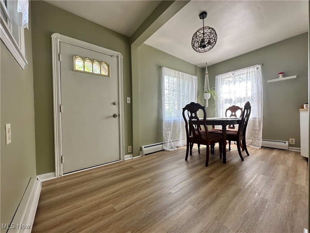 1624 Krumroy Road Akron, OH 44306 - Photo 10 of 47 Dining space with baseboard heating, a chandelier, and light wood finished floors