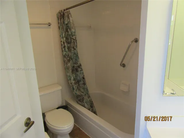 a bathroom with a toilet and shower