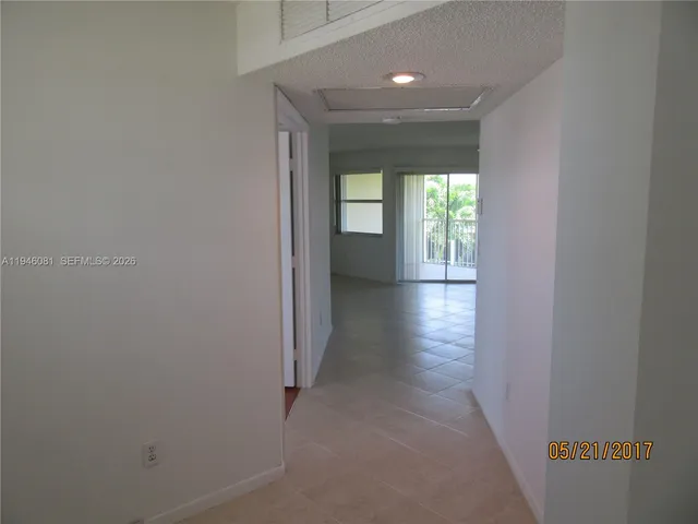 a view of hallway with wooden floor
