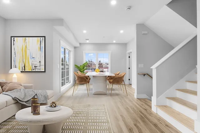 a kitchen with kitchen island granite countertop a sink a stove and cabinets