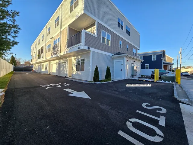a view of empty room with wooden floor and window