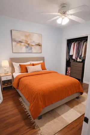 a bedroom with a bed and wooden floor