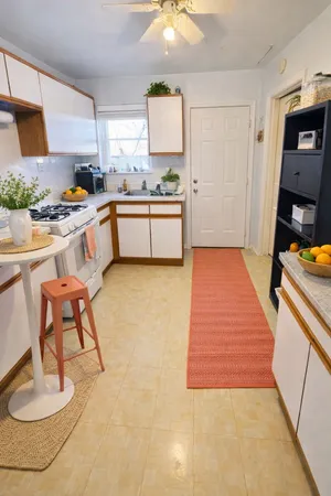 a kitchen with a sink appliances and cabinets