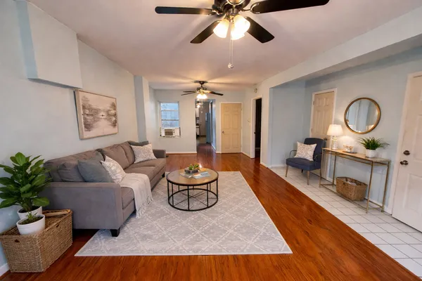 a living room with furniture and a wooden floor