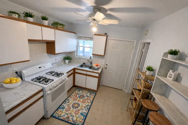 a kitchen with a stove a sink and a refrigerator
