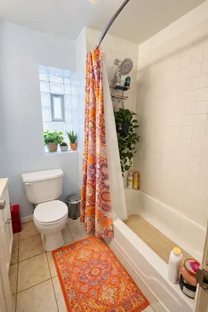 a bathroom with a toilet and a bathtub