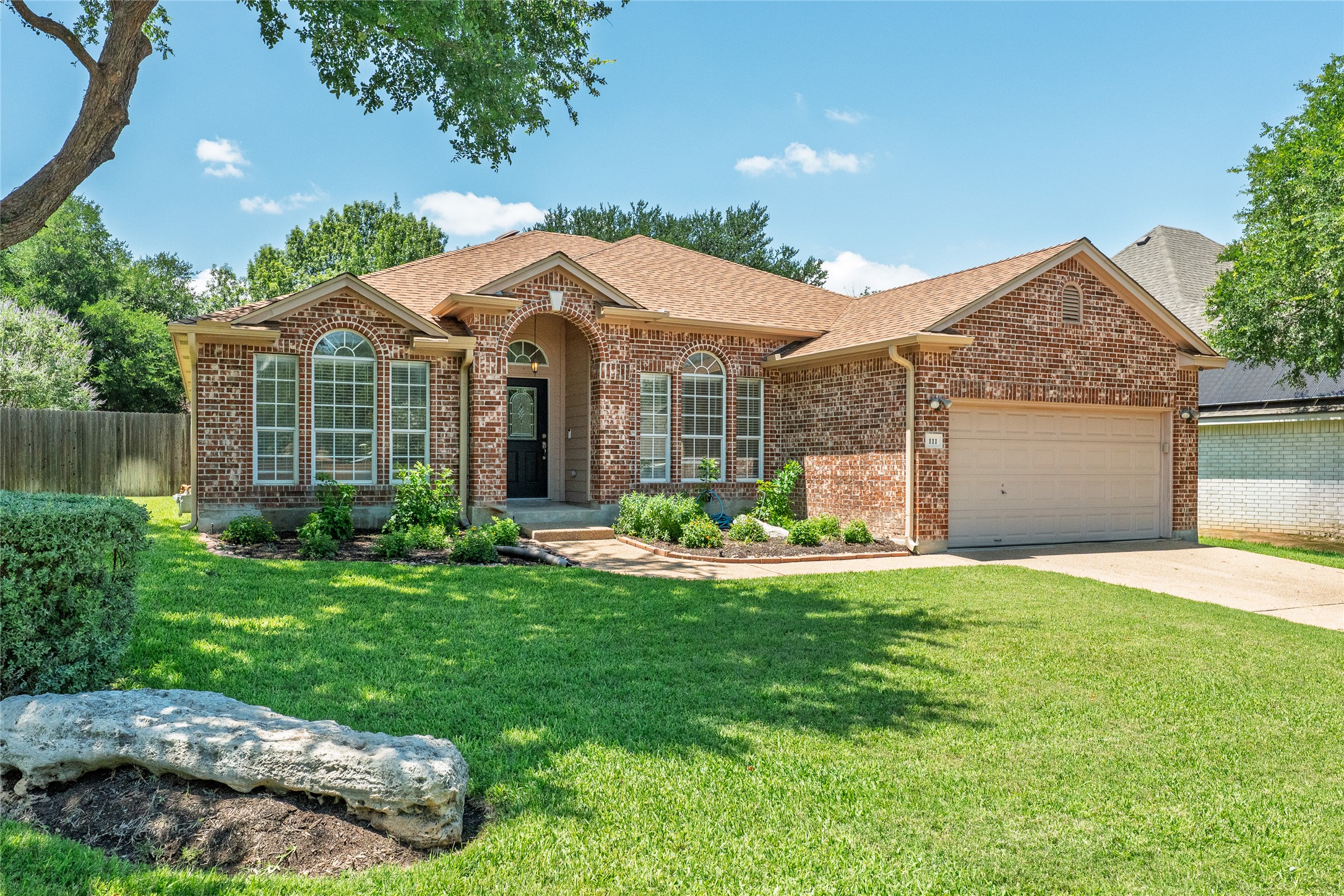 111 Arrowhead Lane Georgetown, TX 78628 - Photo 2 of 40 a front view of a house with a yard and garage