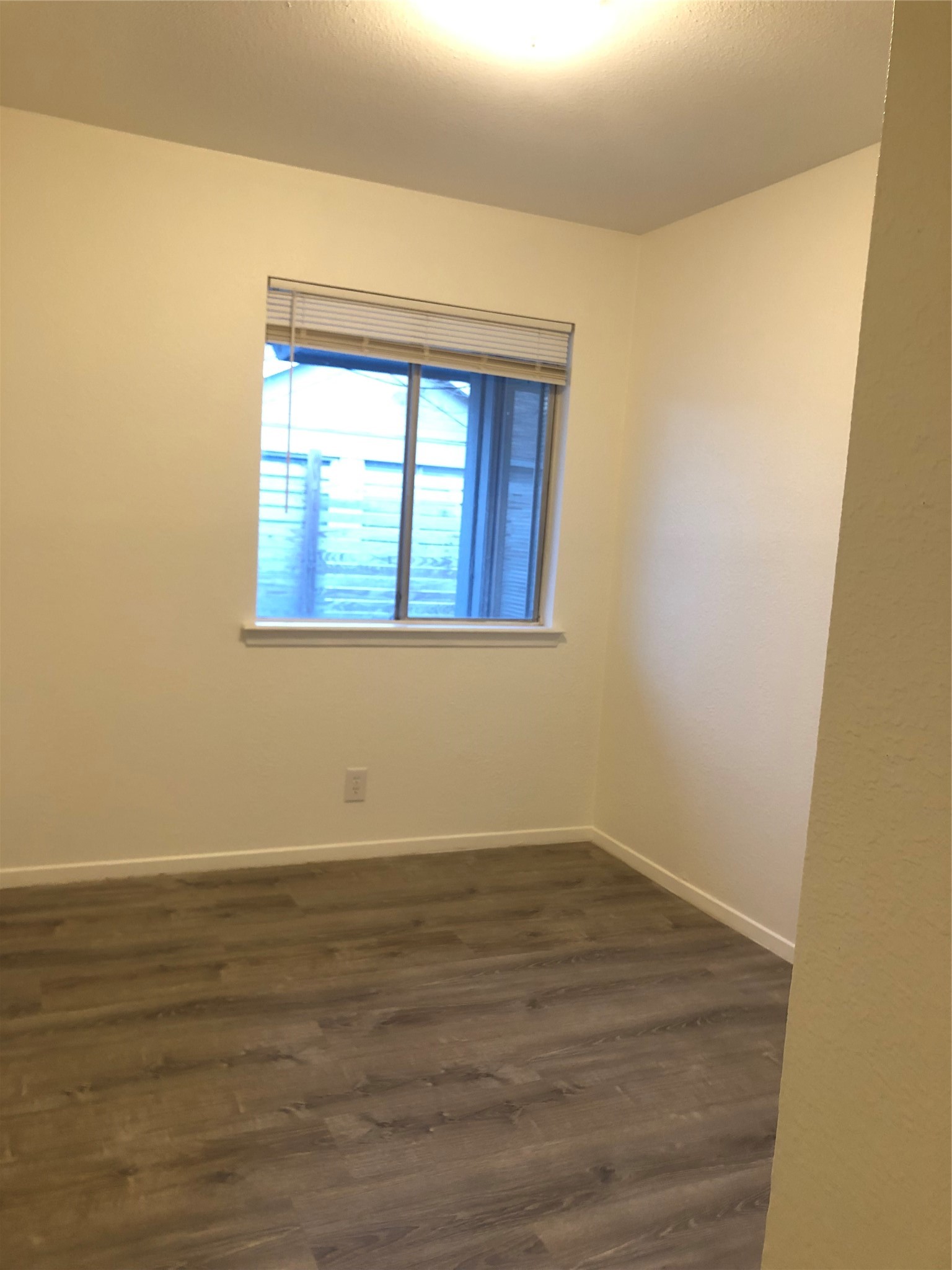 6502 South 1st Street, Unit 102 Austin, TX 78745 - Photo 26 of 26 a view of an empty room with wooden floor and a window