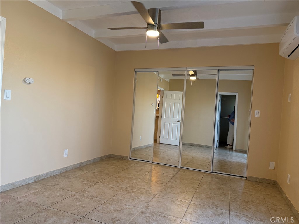 37700 Van Fleet Street, Unit 7 Cathedral City, CA 92234 - Photo 5 of 7 an empty room with closet and a chandelier fan