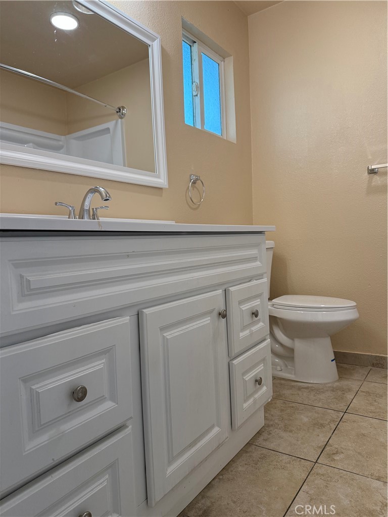 37700 Van Fleet Street, Unit 7 Cathedral City, CA 92234 - Photo 7 of 7 a bathroom with a toilet sink and mirror
