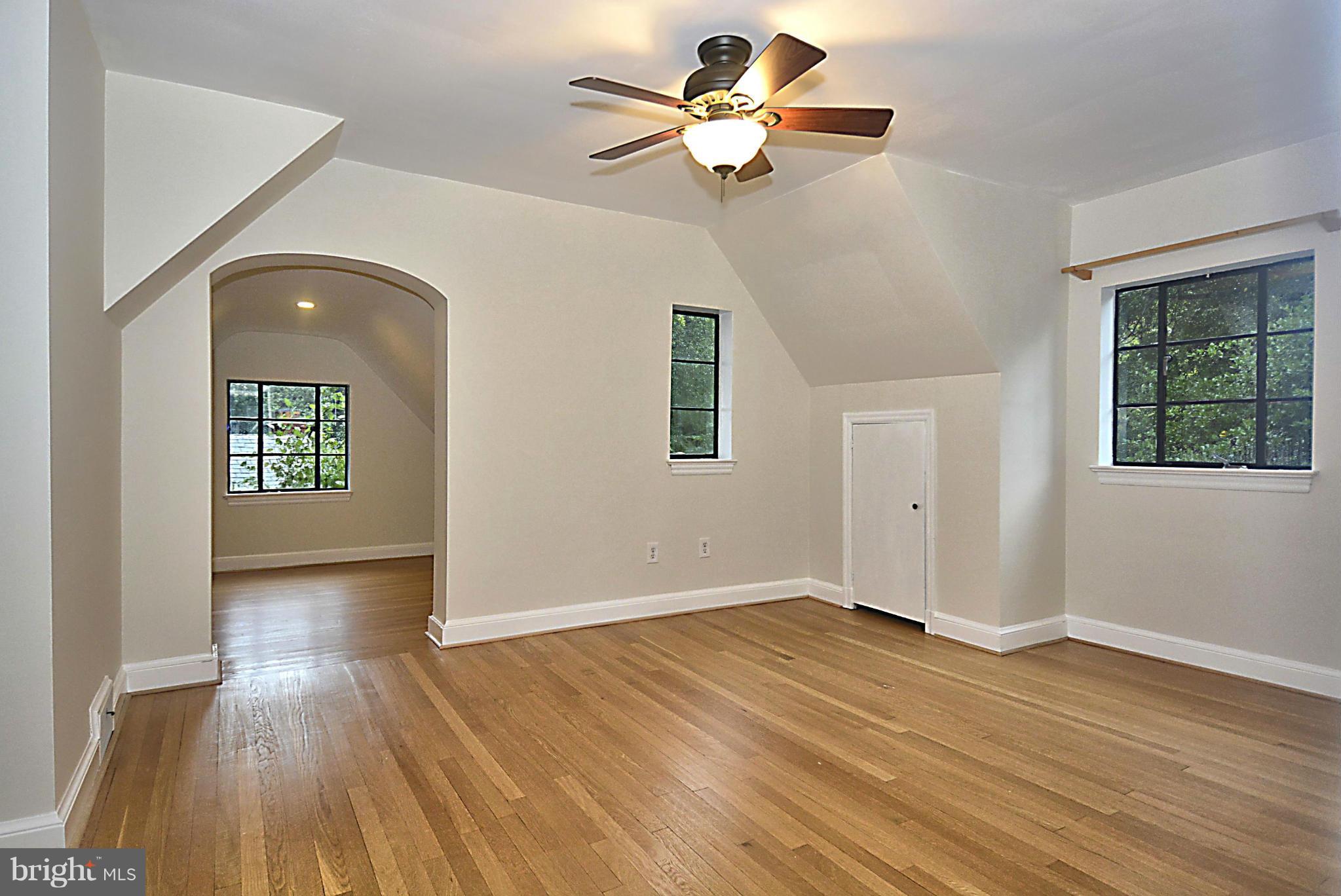 16 Sussex Road Silver Spring, MD 20910 - Photo 14 of 25 a view of an empty room with wooden floor and a window