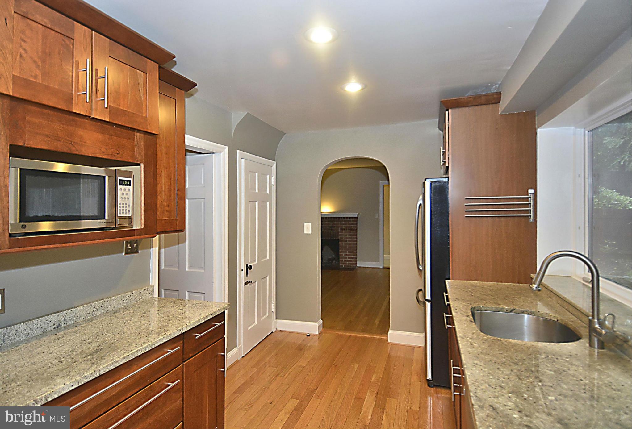 16 Sussex Road Silver Spring, MD 20910 - Photo 3 of 25 a kitchen with stainless steel appliances granite countertop a sink and a refrigerator