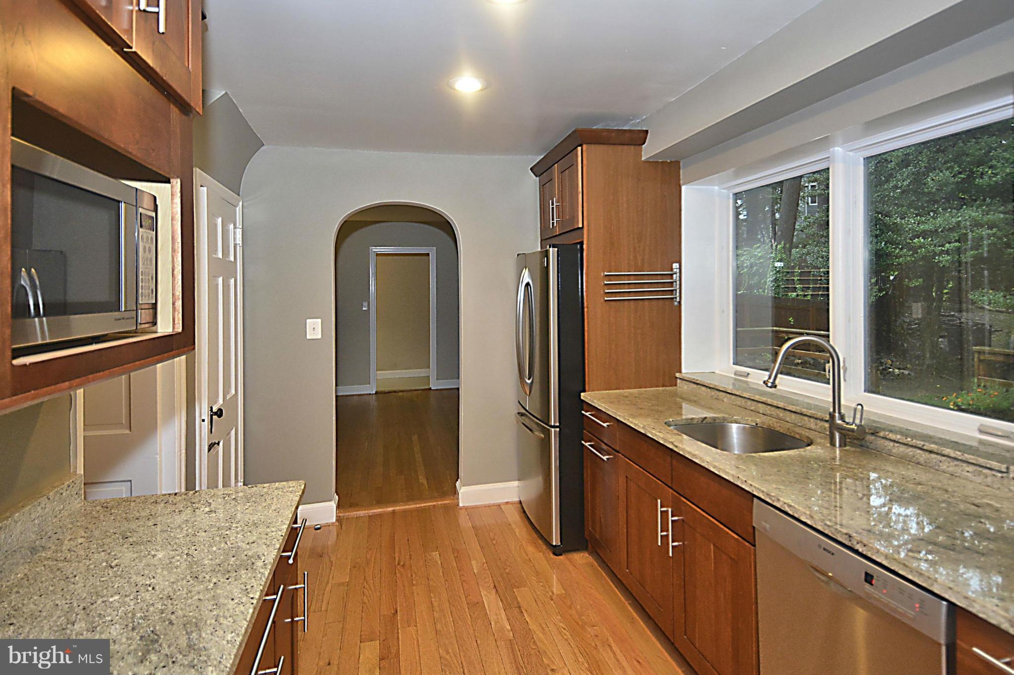 16 Sussex Road Silver Spring, MD 20910 - Photo 4 of 25 a kitchen with granite countertop a sink and refrigerator
