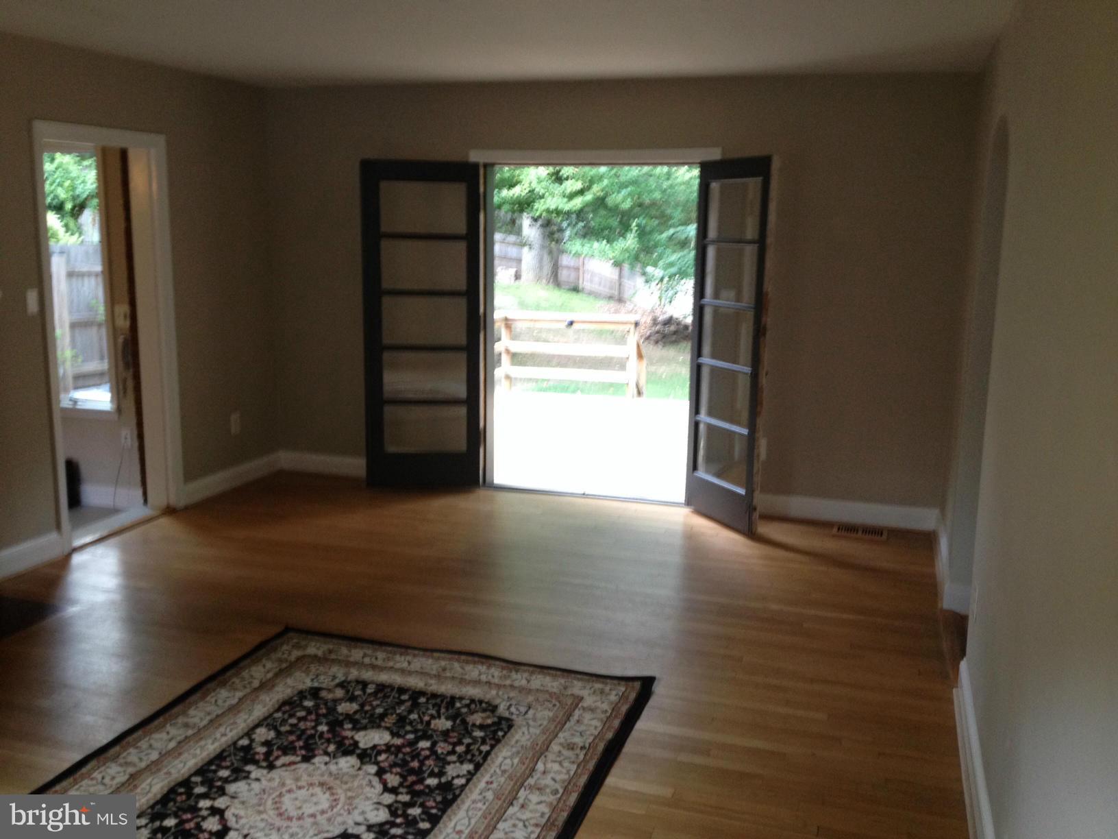 16 Sussex Road Silver Spring, MD 20910 - Photo 7 of 25 an entryway with an empty room and wooden floor