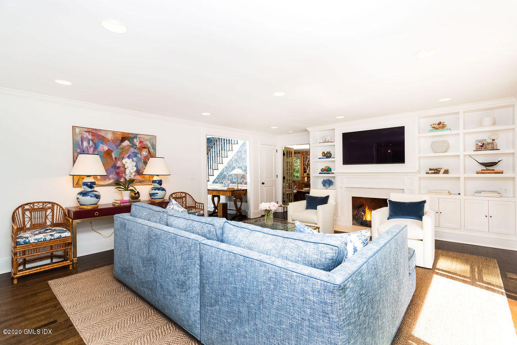 14 Dingletown Road Greenwich, CT 06830 - Photo 14 of 56 a living room with furniture a fireplace and a flat screen tv