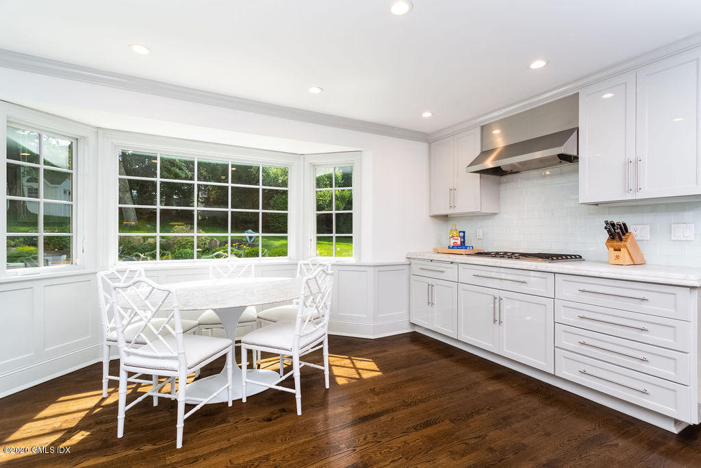 14 Dingletown Road Greenwich, CT 06830 - Photo 19 of 56 a kitchen with a table chairs refrigerator and cabinets
