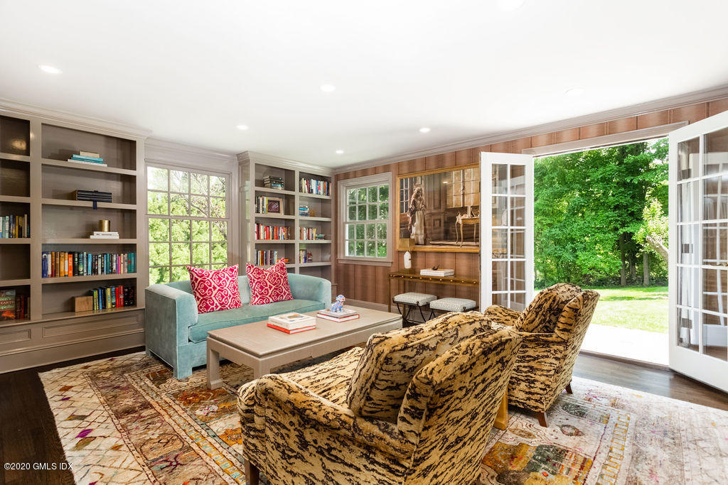 14 Dingletown Road Greenwich, CT 06830 - Photo 27 of 56 a living room with furniture and a book shelf